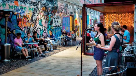 放輕鬆欣賞西譜耶啤酒花園的現場音樂演奏，它位於厄巴納市中心，以集裝箱做為營業店面