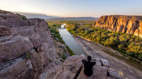 Hiker taking in views of the Rio Grande in Big Bend National Park, Texas