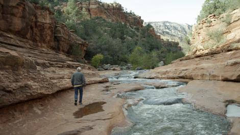 Ed Mell walking through a canyon in Sedona