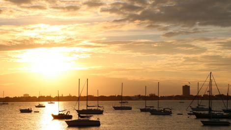 Sun sets over boats anchored in Sarasota Bay