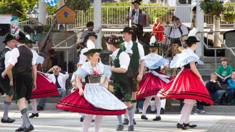 Town residents dancing in traditional Bavarian clothing Town residents dancing in traditional Bavarian clothing