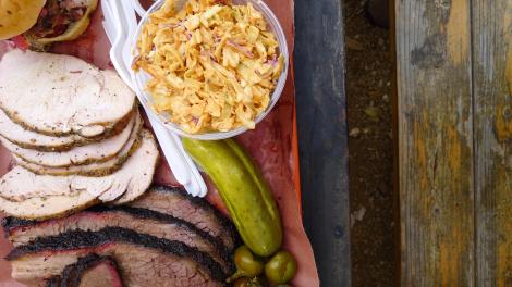 An assortment of meats with a pickle and side of coleslaw in Austin, Texas