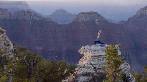 Yoga poses on top of rock formation in Grand Canyon National Park in Arizona Yoga poses on top of rock formation in Grand Canyon National Park in Arizona