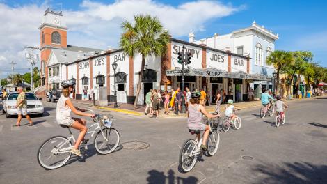 Biking past Sloppy Joe's Bar on Duval Street in Key West, Florida Biking past Sloppy Joe's Bar on Duval Street in Key West, Florida