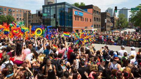 Pride parade passing through the intersection of Addison and Halsted streets Pride parade passing through the intersection of Addison and Halsted streets