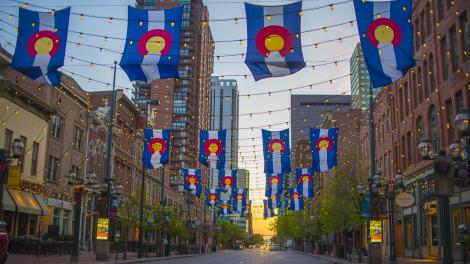 Colorado state flags and lights strung over Larimer Square in Denver, Colorado