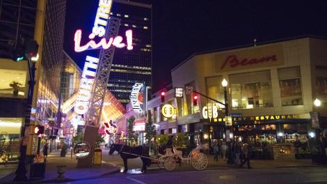Horse-drawn carriage tours and lively nightlife in downtown Louisville, Kentucky