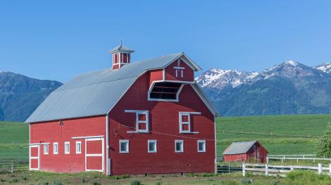 Wallowa Mountains serve as a backdrop for a crisp red barn in Eastern Oregon Wallowa Mountains serve as a backdrop for a crisp red barn in Eastern Oregon