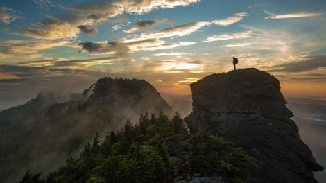 A lone hiker on the summit of Grandfather Mountain in North Carolina A lone hiker on the summit of Grandfather Mountain in North Carolina