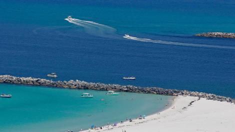 Aerial view of white-sand beaches and turquoise waters at Shell Island Pass in Panama City Beach, Florida