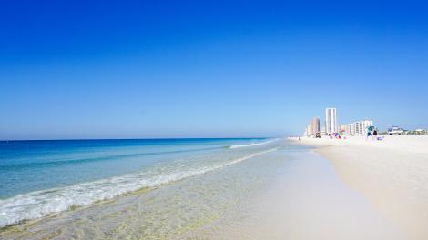 Crystal-clear waters meeting the white sand of Orange Beach, Alabama