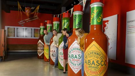 Posing with life-sized TABASCO hot sauce bottles on the TABASCO Brand Factory Tour & Museum in Avery Island, Louisiana Posing with life-sized TABASCO hot sauce bottles on the TABASCO Brand Factory Tour & Museum in Avery Island, Louisiana