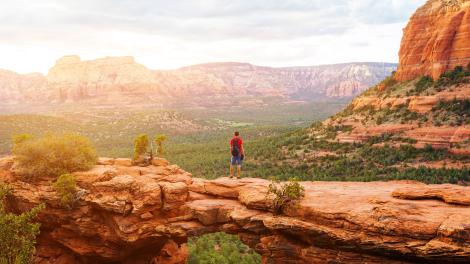 A hiker on Devils Bridge in Coconino National Forest near Sedona, Arizona