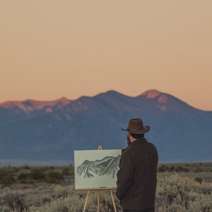 An artist in the field drawing the landscapes of New Mexico An artist in the field drawing the landscapes of New Mexico