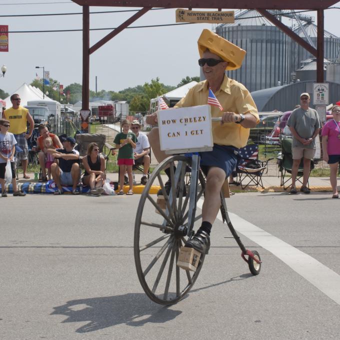 Cyclist wearing a "Cheesehead" hat along a parade route in Green Bay, Wisconsin Cyclist wearing a "Cheesehead" hat along a parade route in Green Bay, Wisconsin