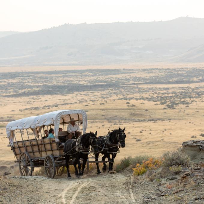 A covered wagon travels the historic roads just outside Casper, Wyoming