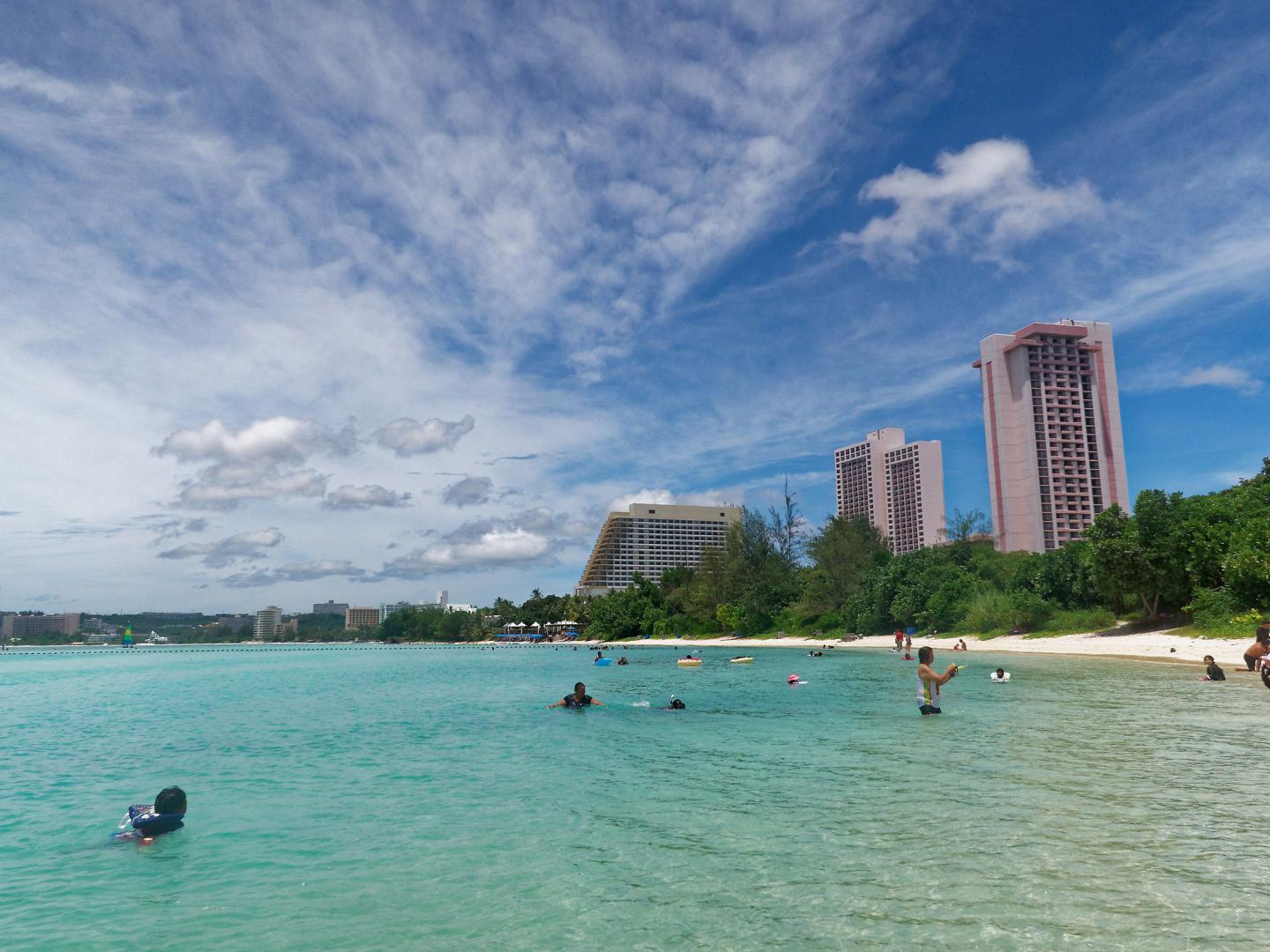 Beachgoers playing in the surf at Ypao Beach in Guam Beachgoers playing in the surf at Ypao Beach in Guam