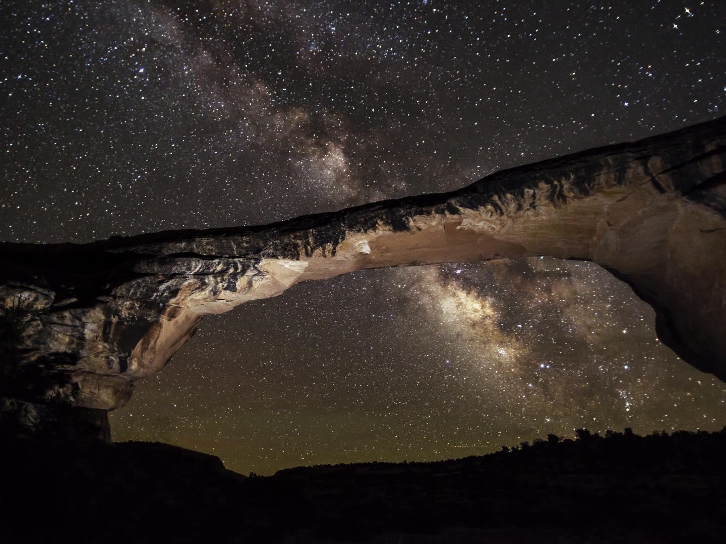 Looking up at the starry sky and Owachomo Bridge in Natural Bridges National Monument, Utah Looking up at the starry sky and Owachomo Bridge in Natural Bridges National Monument, Utah
