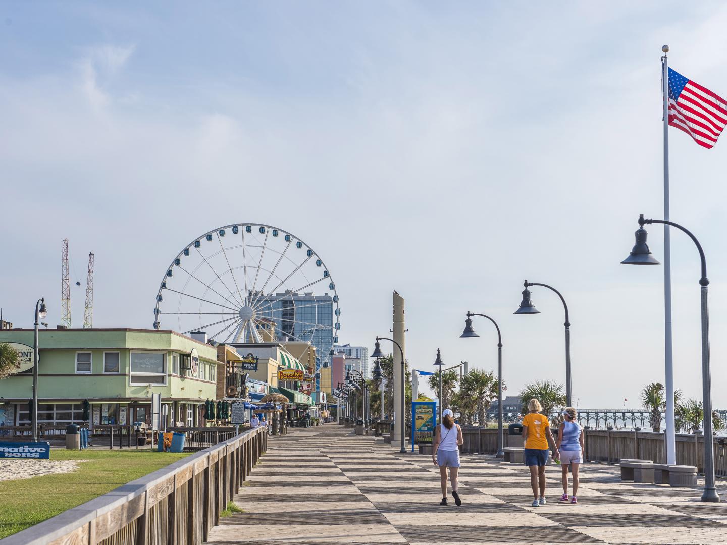 Walking along the Myrtle Beach Boardwalk in South Carolina Walking along the Myrtle Beach Boardwalk in South Carolina