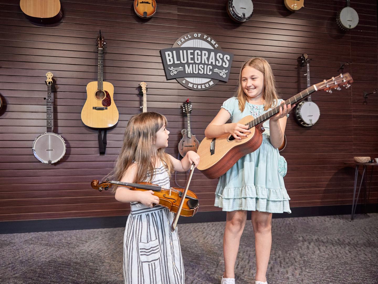 Playing musical instruments in an exhibit at the Bluegrass Music Hall of Fame & Museum in Owensboro, Kentucky