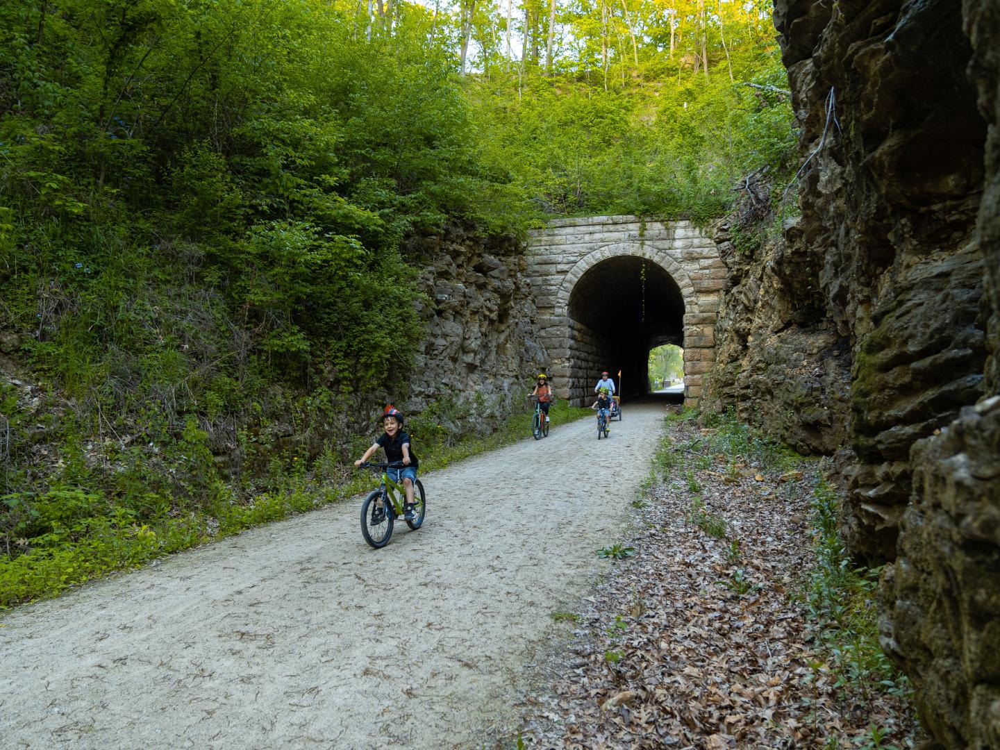 Family cycling down a path in Katy Trail State Park in Missouri