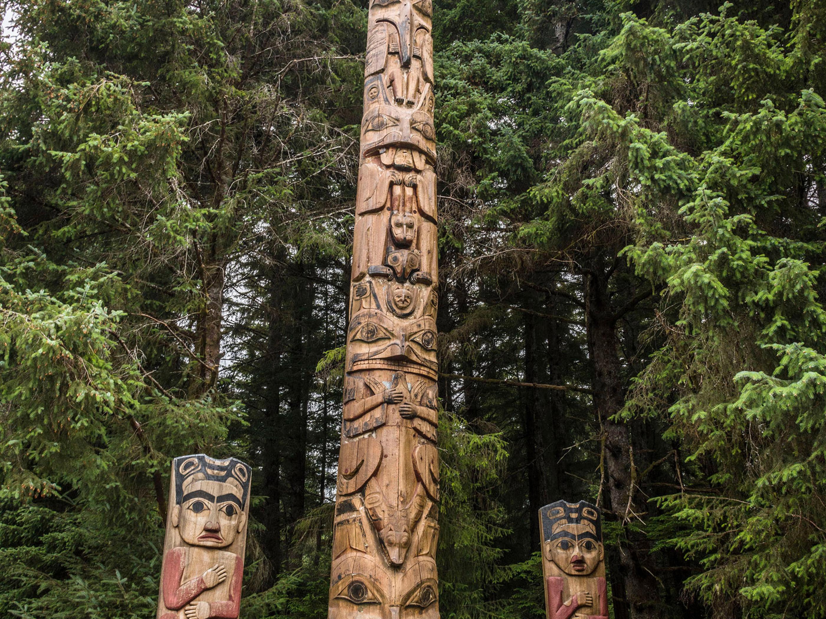 Viewing totem poles in Sitka National HIstorical Park, Alaska Viewing totem poles in Sitka National HIstorical Park, Alaska