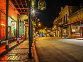 Nighttime view of the 1892 New Orleans Hotel and Spring Street downtown