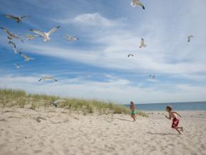 Children playing on a beach in The Hamptons