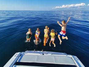 Kids jumping off a boat into Lake Michigan near Holland, Michigan Kids jumping off a boat into Lake Michigan near Holland, Michigan
