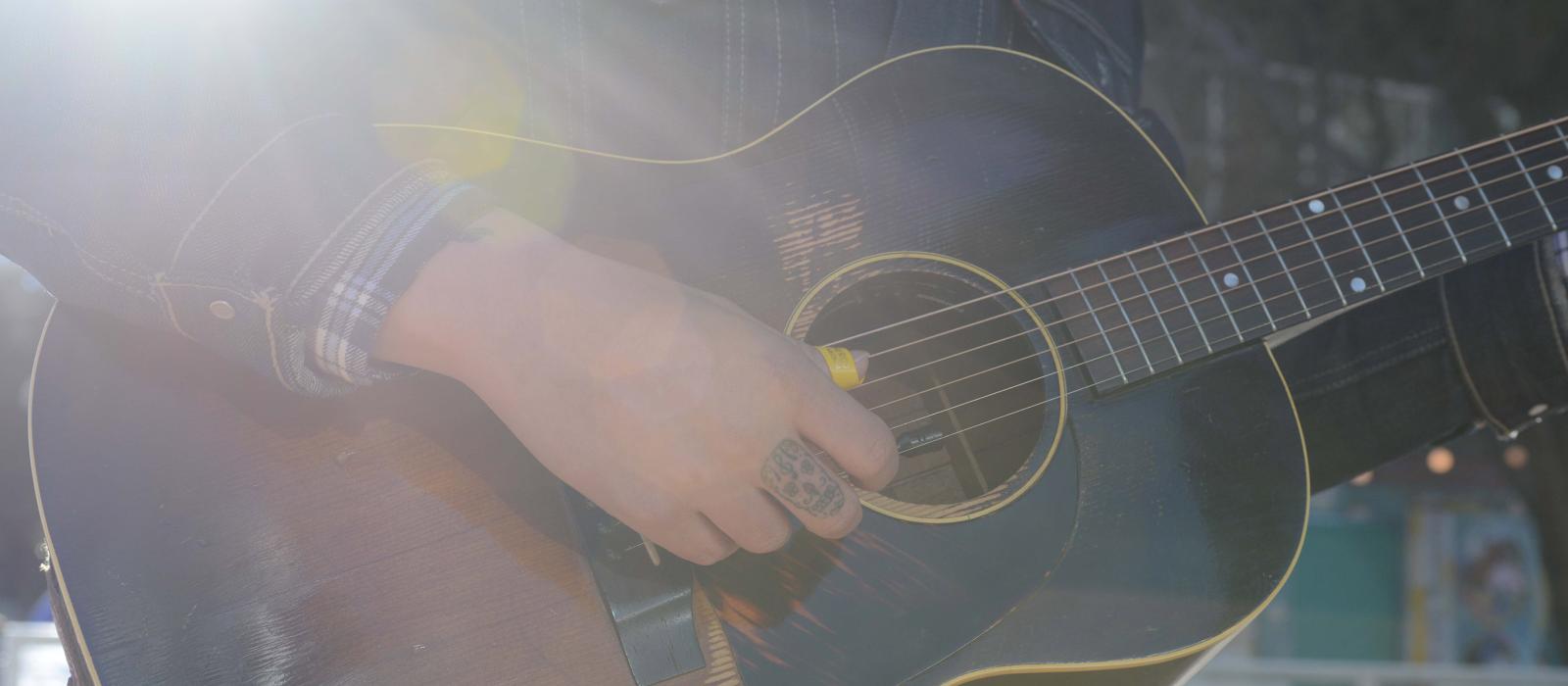 Playing the guitar on a Houston, Texas street