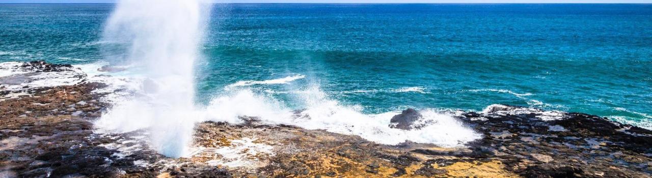 A powerful burst of seawater at Spouting Horn in Kauaʻi