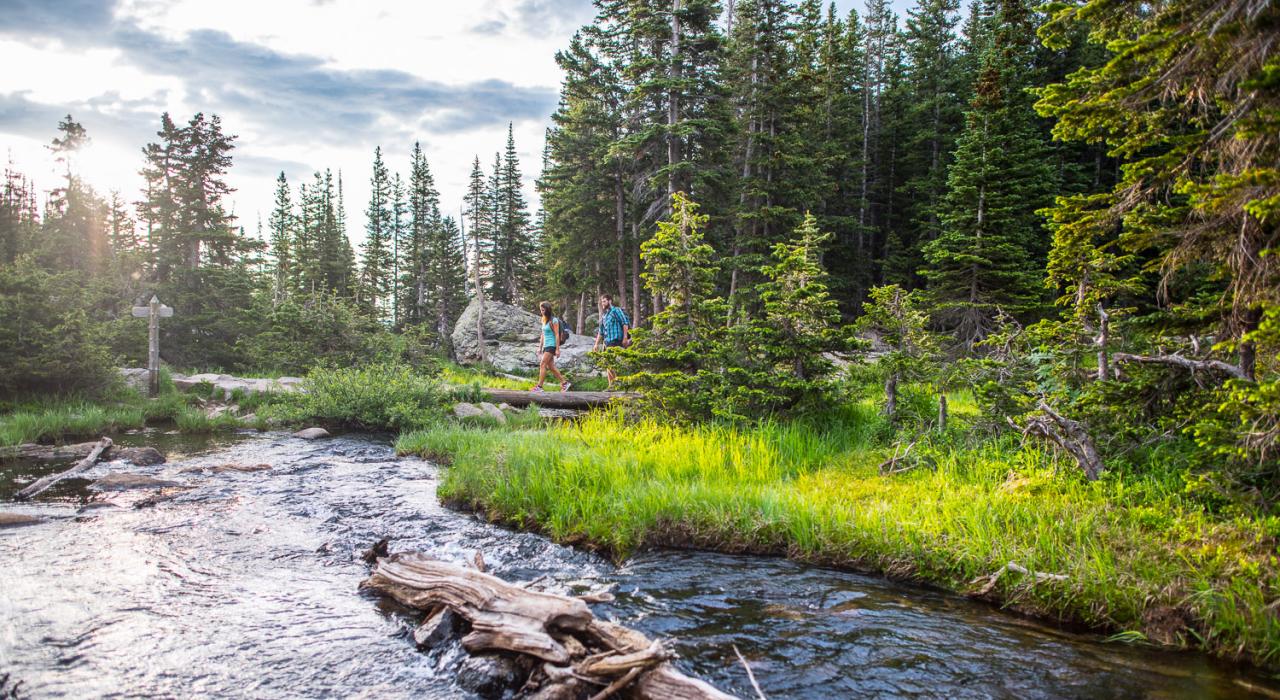 Couple hiking through pristine Colorado wilderness Couple hiking through pristine Colorado wilderness