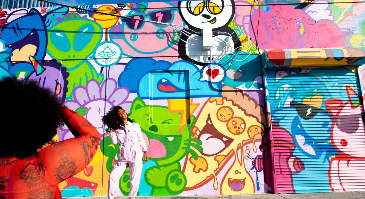 Posing in front of street art in the creative district of Wynwood