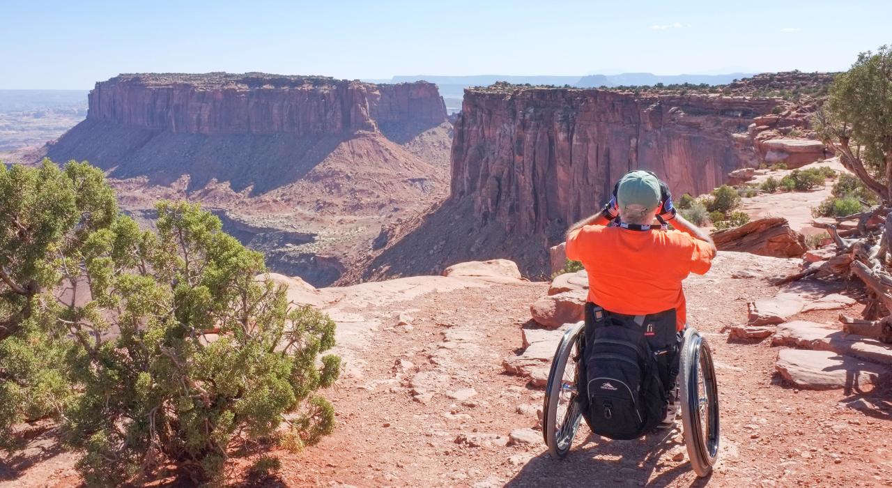 Visitor taking in the impressive views at Rainbow Point in Dead Horse Point State Park, Utah Visitor taking in the impressive views at Rainbow Point in Dead Horse Point State Park, Utah
