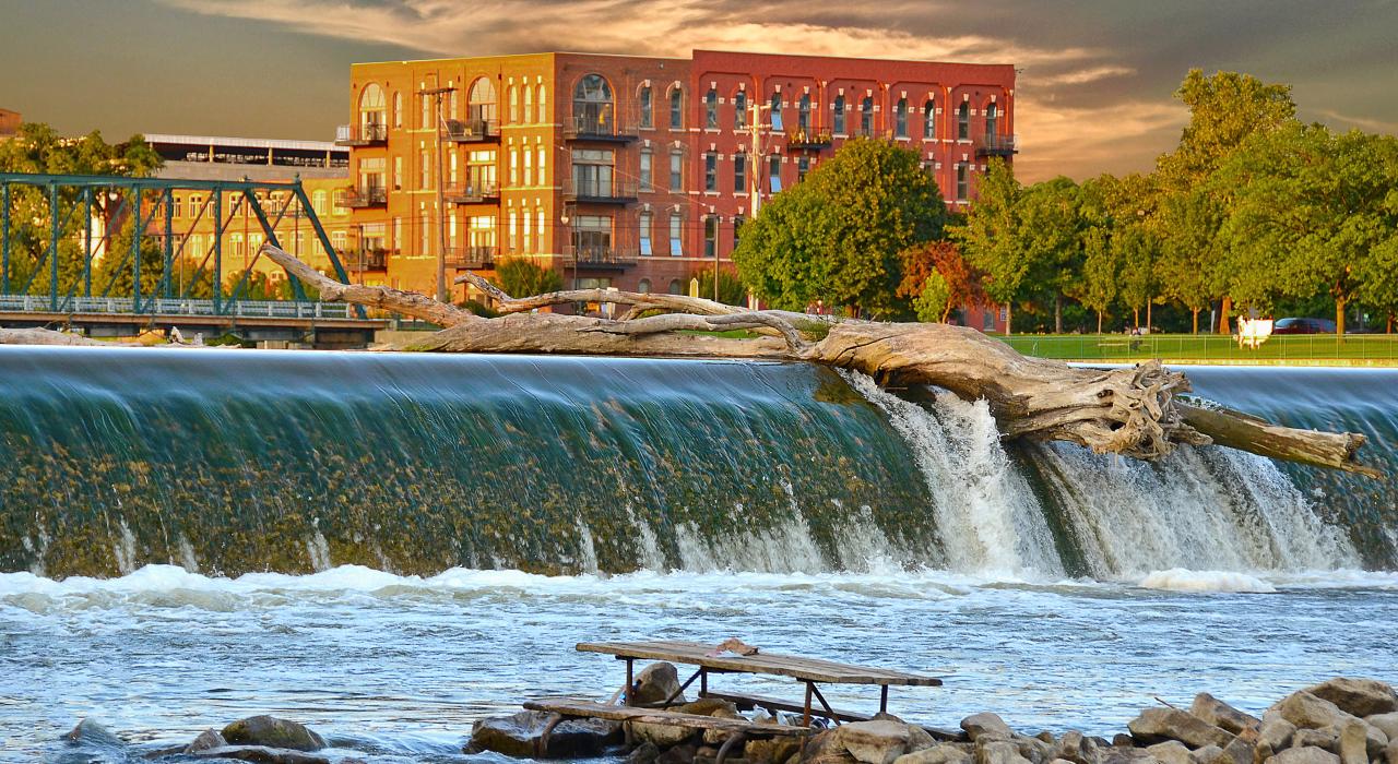 Driftwood floats over a dam on the Grand river