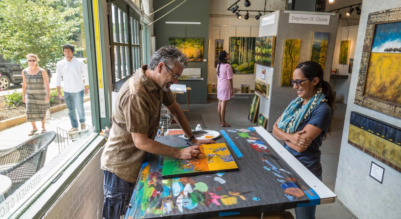 Artist at work in a gallery in the River Arts District