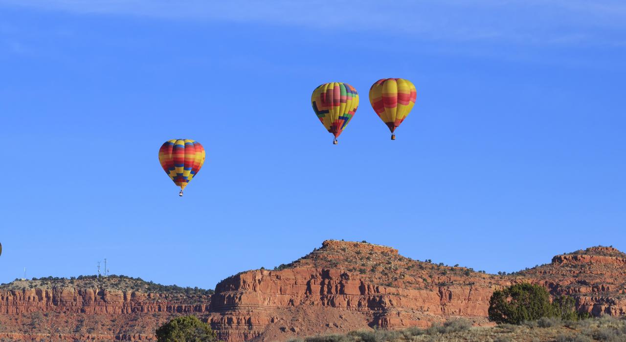 Hot-air balloons soaring over the Vermilion Cliffs