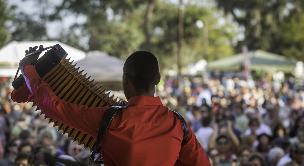 An accordion player overlooking the crowd at the Festivals Acadiens et Creoles