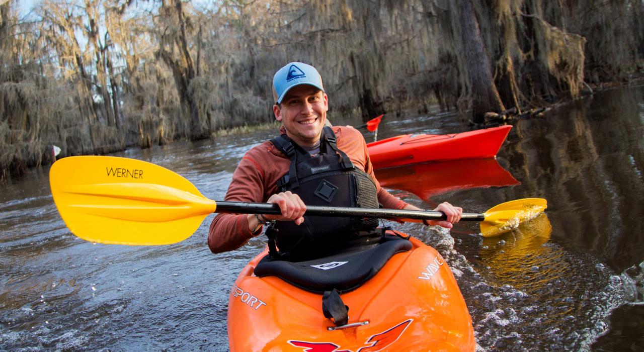 Happy kayaker exploring the swamps