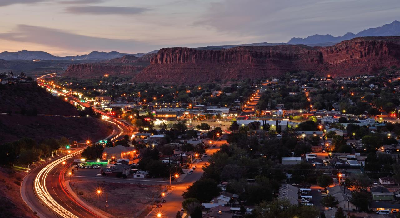 Neon lights of Bluff Street framing the city
