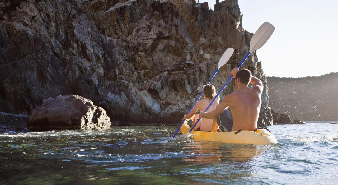 Kayaking toward a rocky cove