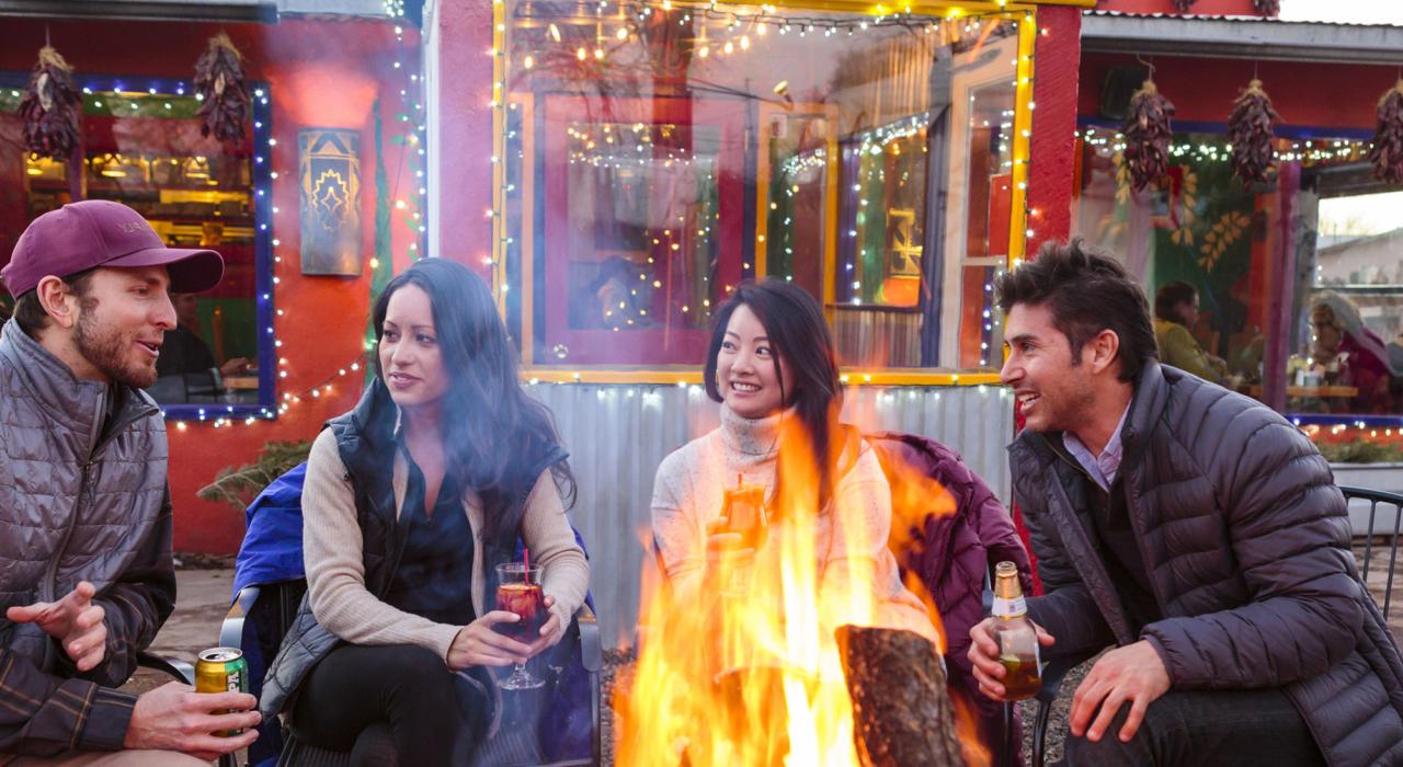 Outdoor socializing around a storefront campfire Outdoor socializing around a storefront campfire