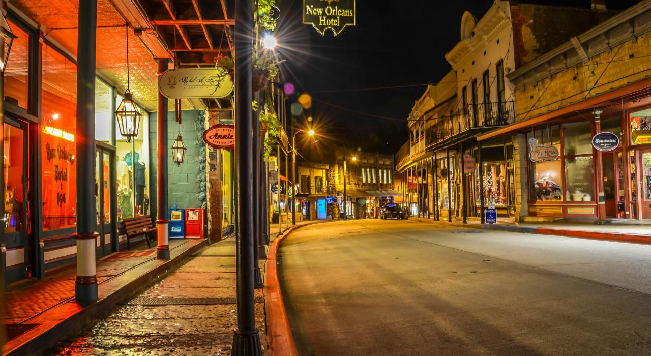 Nighttime view of the 1892 New Orleans Hotel and Spring Street downtown