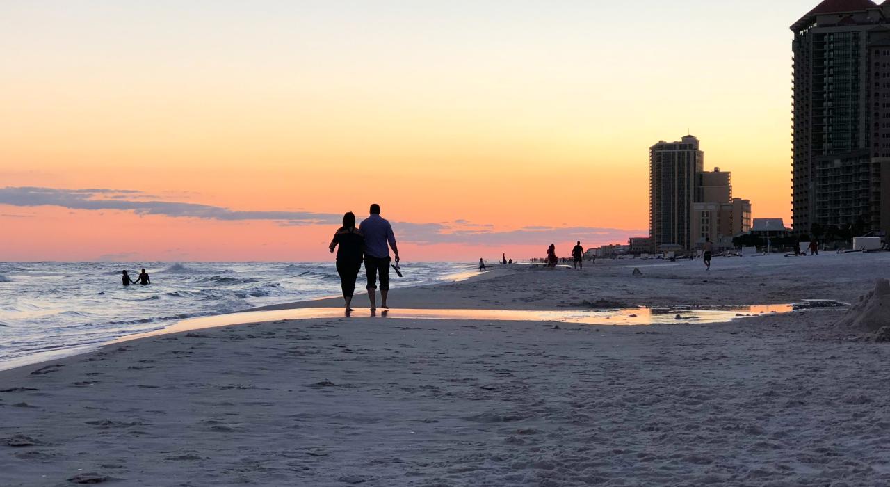 A romantic stroll through sugar-soft sand at sunset