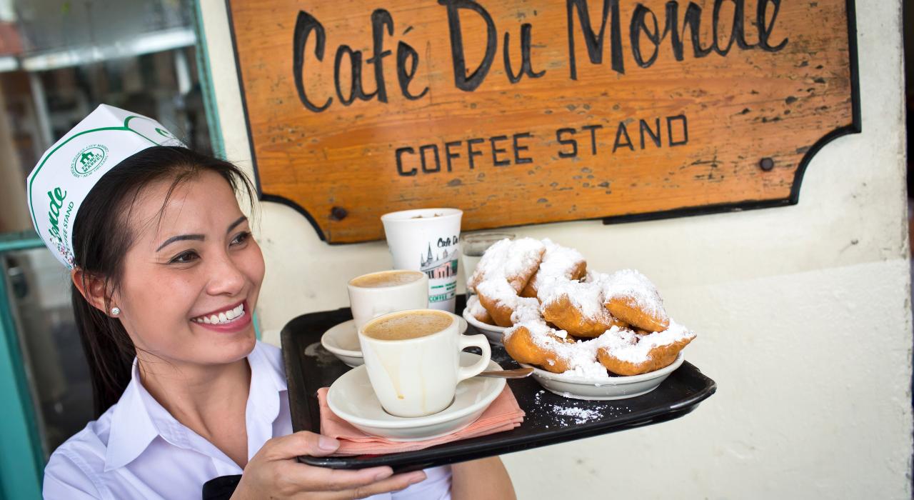 Serving coffee and beignets at Café du Monde Serving coffee and beignets at Café du Monde