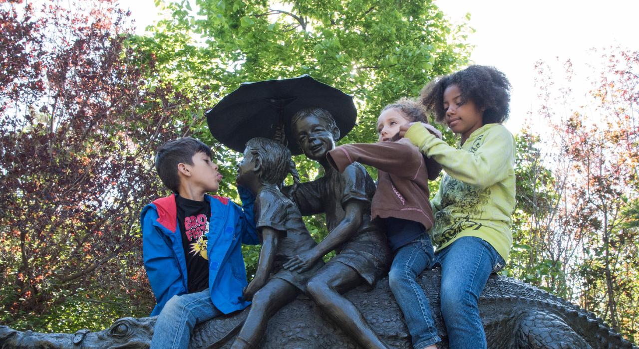 Kids playing among the bronze art at Benson Sculpture Garden in Loveland