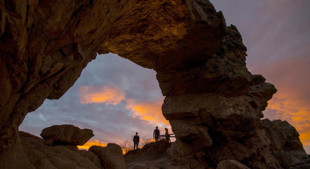 Sunset through a red rock formation at Devil’s Backbone Open Space