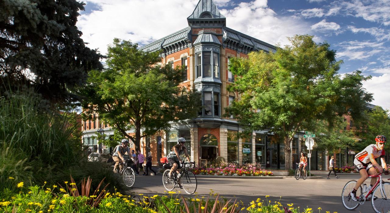 Biking by the historic Linden Hotel in downtown Fort Collins