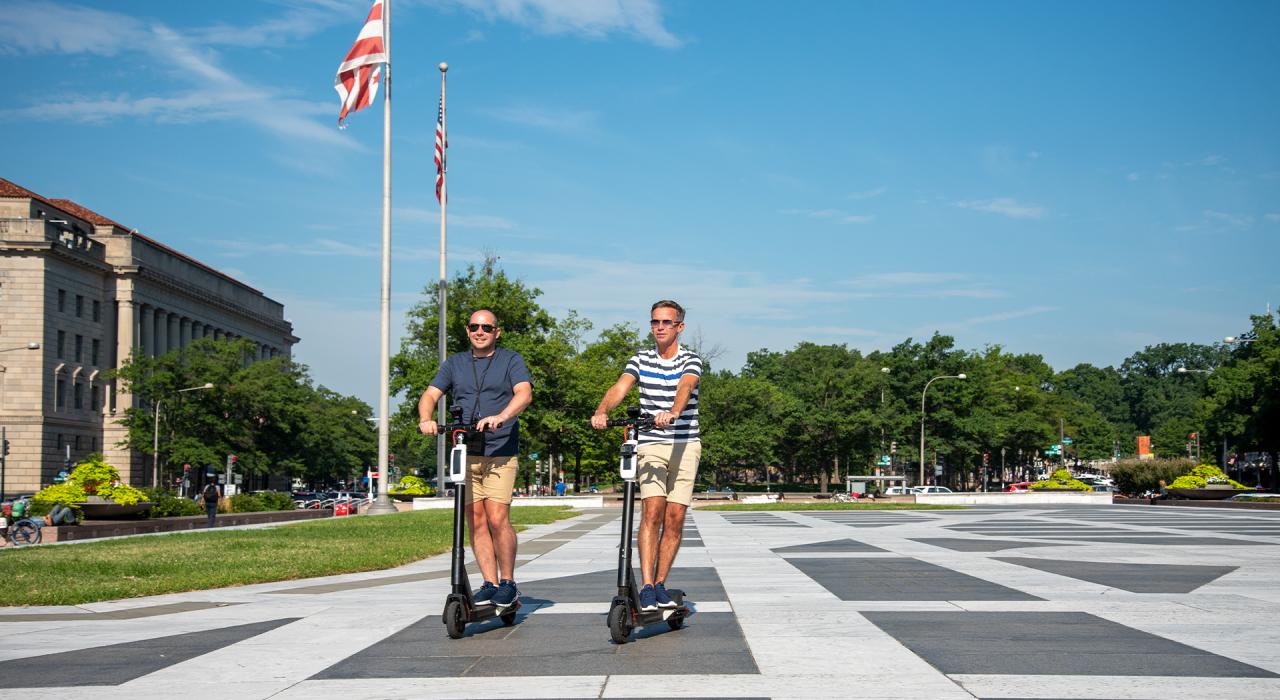Couple exploring Washington, D.C., on scooters Couple exploring Washington, D.C., on scooters