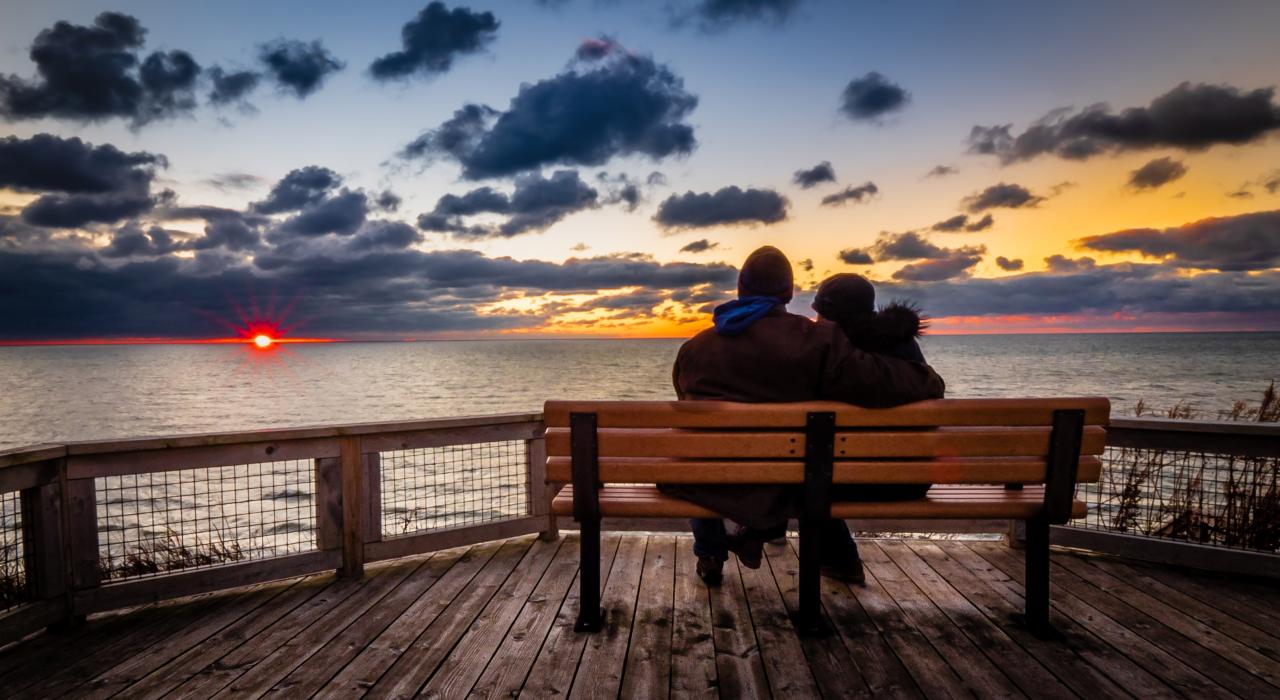 Couple watching a Lake Michigan sunset from Tunnel Park Couple watching a Lake Michigan sunset from Tunnel Park